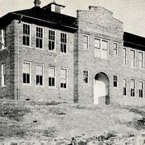 Multistory brick building with arched doorway