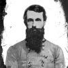 White man with dark hair and long beard in military uniform