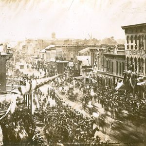 Parade with crowd and horses on crowded city street