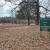 Small cemetery in field with green sign