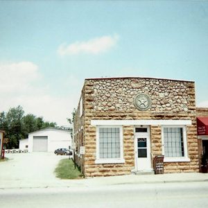 Brick and stone building with star emblem on street