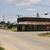 Single-story brick building and single-storefront on rural road