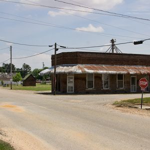 Single-story brick building and single-storefront on rural road