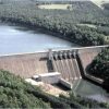 Concrete dam with lake and countryside in the distance