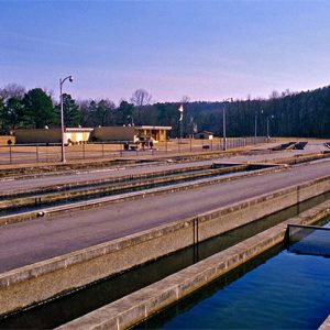 Concrete holding tanks with building and parking lot