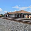 Diesel train arriving at brick depot building