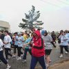 Group of white men and women walking on city street