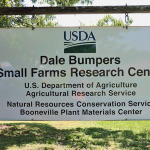 Sign saying "USDA Dale Bumpers Small Farms Research Center" hanging on brick column