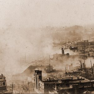 Destroyed buildings and smoke on city street