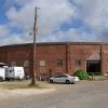 Brick building with parking lot and telephone pole on street