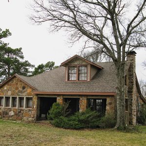 Stone house with tree and bushes