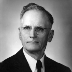 White man with glasses in suit and tie