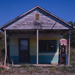 Abandoned gas station building and gas pumps