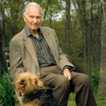 white man with dog in woods