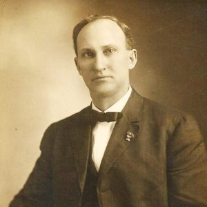 White man in suit and bow tie