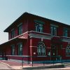 Two-story brick railroad depot building with arched windows