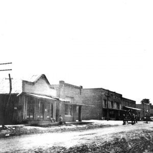 Man taking a horse-drawn wagon down a dirt road