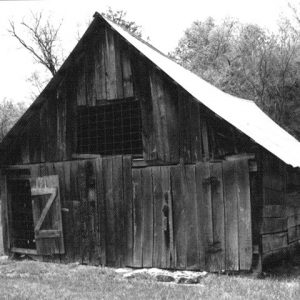 A-frame wooden barn with screen on window and door opening