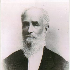 Old white man with long beard in suit and white shirt