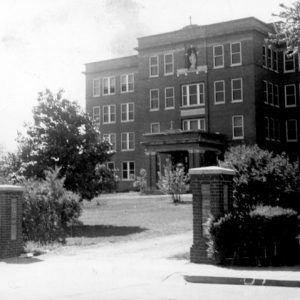 Four-story building with entrance columns and driveway