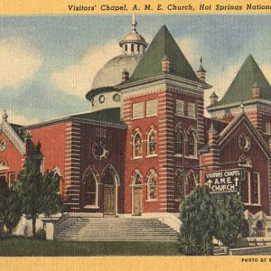 Multistory building with twin towers and dome on post card