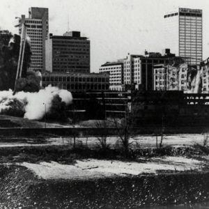 City skyline with collapsing building and smoke