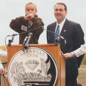 Portrait of white man in suit and tie and young white girl at lectern