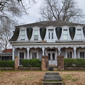 Two-story house with brick and iron fence