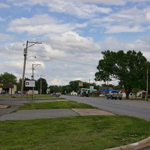 Brick buildings on street with service station in the background