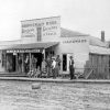 Group of people posing outside "Brinneman Bros Dry Goods Groceries Fine Shoes and Feed Hunter Arkansas"