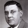 White man with glasses in suit and tie