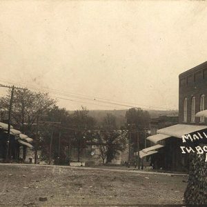 Brick storefronts and power lines on town road