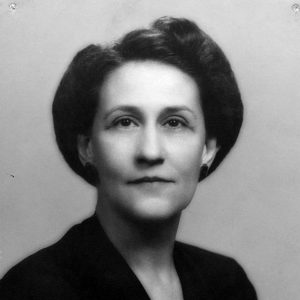 White woman with short hair smiling in black top