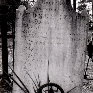 Weathered white marble grave marker