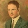 Young white man in green suit and tie