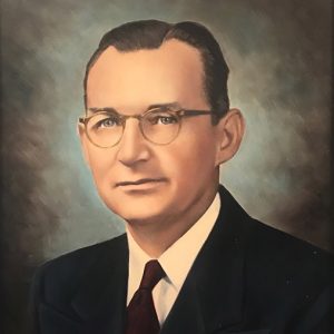 White man with glasses in suit and tie