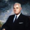 Older white man with glasses in suit and tie