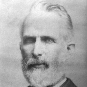 Old white man with beard in suit and bow tie