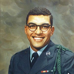 Young smiling African-American man in military uniform with glasses