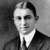 White man with glasses in suit and tie