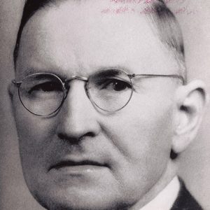 White man with glasses in suit and tie