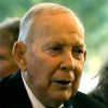 Old white man in suit and blue bow tie