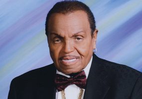 Older African-American man smiling in suit and bow tie