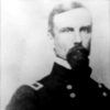 White man with dark hair beard and mustache in military uniform