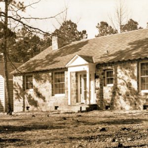 House with rock walls and outbuildings