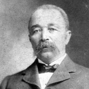 African-American man with mustache in suit and bow tie