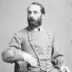 White man with beard sitting in gray military uniform