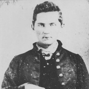 White man in military uniform holding revolver