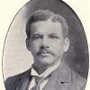 African-American man with mustache in suit and tie