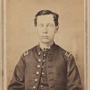 Young white man sitting in military uniform